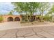Wide angle view of front exterior showing a tile roof and a two-car garage at 11051 N 45Th Pl, Phoenix, AZ 85028