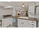 Bright kitchen boasts white cabinets, stainless steel appliances, and an open layout to the living area at 11051 N 45Th Pl, Phoenix, AZ 85028