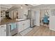 Bright kitchen featuring white cabinetry, stainless steel appliances, and a breakfast bar at 11051 N 45Th Pl, Phoenix, AZ 85028