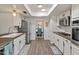 Well-lit kitchen with white cabinets, stainless steel appliances, and view to dining area at 11051 N 45Th Pl, Phoenix, AZ 85028