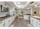 Bright kitchen with stainless steel appliances, white cabinets, and adjacent breakfast nook offers a skylight at 11051 N 45Th Pl, Phoenix, AZ 85028