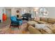 Cozy living room featuring plush seating, a piano, and large, light-filled windows at 11051 N 45Th Pl, Phoenix, AZ 85028