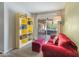 This living room offers a large sliding glass door with a comfortable sofa and colorful bookcase at 11051 N 45Th Pl, Phoenix, AZ 85028