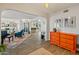 Open-concept living room featuring wood floors, an orange dresser, and ample natural light at 11051 N 45Th Pl, Phoenix, AZ 85028