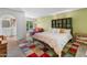 Bright bedroom with a colorful rug, cozy seating, and sliding glass doors leading to the backyard pool at 11051 N 45Th Pl, Phoenix, AZ 85028