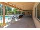 Spacious covered patio with string lights, comfortable seating, and views of the pool and lush backyard at 11051 N 45Th Pl, Phoenix, AZ 85028