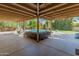 Large covered patio featuring an outdoor seating area, dining space, and a view of the pool and landscaped yard at 11051 N 45Th Pl, Phoenix, AZ 85028