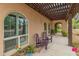 Covered patio with seating area and desert landscaping at 11051 N 45Th Pl, Phoenix, AZ 85028