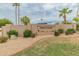 Desert Gardens community sign amid desert landscaping with gravel, palms, and a grass border at 11051 N 45Th Pl, Phoenix, AZ 85028