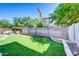 Backyard features an artificial lawn, privacy wall, and an outdoor living space with a fire pit and seating at 1140 E Vermont Dr, Gilbert, AZ 85295