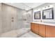 This bathroom features double sinks and a large glass shower with a rainfall shower head at 1140 E Vermont Dr, Gilbert, AZ 85295