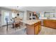 Spacious open-concept kitchen and dining area featuring a granite island, stainless steel appliances, and wood cabinetry at 1140 E Vermont Dr, Gilbert, AZ 85295