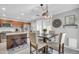 Eat in kitchen with stainless steel appliances, wood cabinets, granite counters, a large window, and a dining table at 1140 E Vermont Dr, Gilbert, AZ 85295