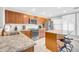 Modern kitchen featuring stainless steel appliances, granite countertops, an island with seating, and stylish wood cabinets at 1140 E Vermont Dr, Gilbert, AZ 85295