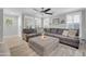 Bright living room with a large gray sectional, neutral decor, shutters, and tile flooring at 1140 E Vermont Dr, Gilbert, AZ 85295