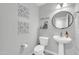 This half bathroom features a pedestal sink and decor at 1140 E Vermont Dr, Gilbert, AZ 85295