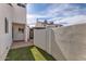 Stucco home shows a private, low-maintenance backyard with artificial turf and brick pavers at 1147 E Belmont Ave, Phoenix, AZ 85020