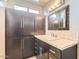 Bathroom featuring a vanity with built-in storage, a stylish mirror, and natural lighting at 1147 E Belmont Ave, Phoenix, AZ 85020