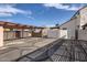 Wide view of the carport with its desert landscaping, attached to the stucco home under a sunny, partly cloudy sky at 1147 E Belmont Ave, Phoenix, AZ 85020