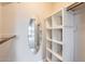 Bright closet features custom shelving, wooden hanging rods, and an elegant oval mirror at 1147 E Belmont Ave, Phoenix, AZ 85020