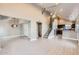 Open-concept living room with hardwood floors, a staircase, and an adjacent modern kitchen at 1147 E Belmont Ave, Phoenix, AZ 85020