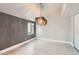 Comfortable living room with wood flooring, a unique light fixture, and neutral color palette at 1147 E Belmont Ave, Phoenix, AZ 85020