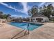 Community pool with an adjacent building surrounded by deck chairs for sunny relaxation at 1147 E Belmont Ave, Phoenix, AZ 85020