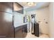 Functional utility room with modern cabinetry, water heater, and water filtration system at 1147 E Belmont Ave, Phoenix, AZ 85020
