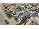 Aerial view of the home's backyard including solar panels, pool, green space, and fire pit at 11915 W Charter Oak Rd, El Mirage, AZ 85335