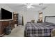 Cozy bedroom with a plaid bedspread, dresser, and a television for comfort and relaxation at 11915 W Charter Oak Rd, El Mirage, AZ 85335