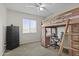 Bright bedroom with a unique lofted bed, dresser, desk, and large window at 11915 W Charter Oak Rd, El Mirage, AZ 85335