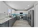 Modern kitchen with stainless steel appliances, granite countertops, subway tile backsplash, and wood-look flooring at 11915 W Charter Oak Rd, El Mirage, AZ 85335