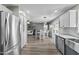 Open-concept kitchen flows into the dining and living areas with stainless appliances and hardwood floors at 11915 W Charter Oak Rd, El Mirage, AZ 85335