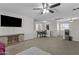 Large living area with desk, entertainment center, ceiling fan and lots of natural light at 11915 W Charter Oak Rd, El Mirage, AZ 85335