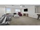 Spacious living room with large windows, plush seating, ceiling fan and entertainment center at 11915 W Charter Oak Rd, El Mirage, AZ 85335