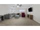 Spacious living room with carpet, large windows, TV and sectional couch for relaxation and entertainment at 11915 W Charter Oak Rd, El Mirage, AZ 85335