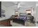 Bedroom with neutral carpet, ceiling fan, and window with wooden blinds offering a relaxing retreat at 11915 W Charter Oak Rd, El Mirage, AZ 85335