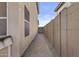 Paver side yard walkway with a gate that provides backyard access at 11915 W Charter Oak Rd, El Mirage, AZ 85335