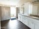 An elegant bathroom with a tiled shower, bright mirrors, double sinks, and modern vanities at 1374 N Alexis Dr, Gilbert, AZ 85234