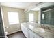 A pristine bathroom featuring a marble countertop vanity with double sinks and ample lighting at 1374 N Alexis Dr, Gilbert, AZ 85234
