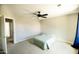 A minimalist bedroom featuring a ceiling fan, neutral walls, and a comfortable single bed at 1374 N Alexis Dr, Gilbert, AZ 85234