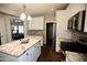 Modern kitchen with white cabinets, an island, granite countertops, and stainless steel appliances at 1374 N Alexis Dr, Gilbert, AZ 85234
