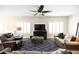 Cozy living room featuring a ceiling fan, modern TV, and comfortable seating at 1374 N Alexis Dr, Gilbert, AZ 85234