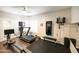 Workout room with hardwood floors, exercise equipment, and natural lighting at 1374 N Alexis Dr, Gilbert, AZ 85234