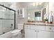 Well-lit bathroom featuring a shower-tub combo, granite counters and ample cabinet space at 15215 S 20Th Pl, Phoenix, AZ 85048