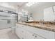 Updated bathroom with dual sinks, granite countertops, and tiled shower at 15215 S 20Th Pl, Phoenix, AZ 85048