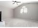 Neutral bedroom with plush carpeting, ceiling fan, and large window at 15215 S 20Th Pl, Phoenix, AZ 85048
