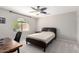 Comfortable bedroom with ceiling fan, desk area and arched window with blinds at 15215 S 20Th Pl, Phoenix, AZ 85048