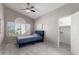Cozy bedroom with a blue bed, ceiling fan, and bright window at 15215 S 20Th Pl, Phoenix, AZ 85048