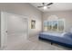 Bedroom with plush carpet, blue bed and an open doorway to another room at 15215 S 20Th Pl, Phoenix, AZ 85048